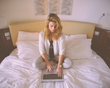 Woman Laptop on Bed