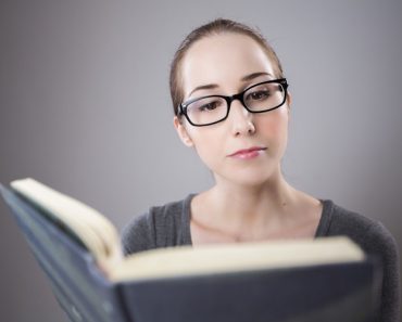 Woman in Glasses reading Book